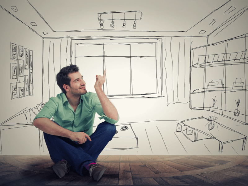 un homme dessinant un appartement neuf à vendre à marcilly-sur-tille